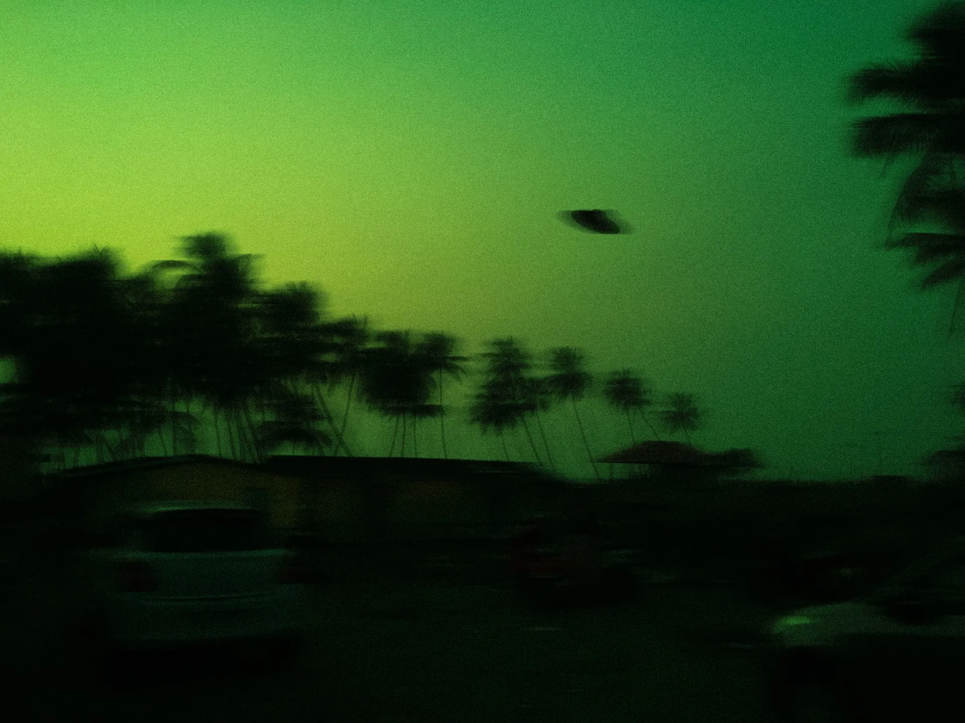 green and black trees under sky with flying saucer