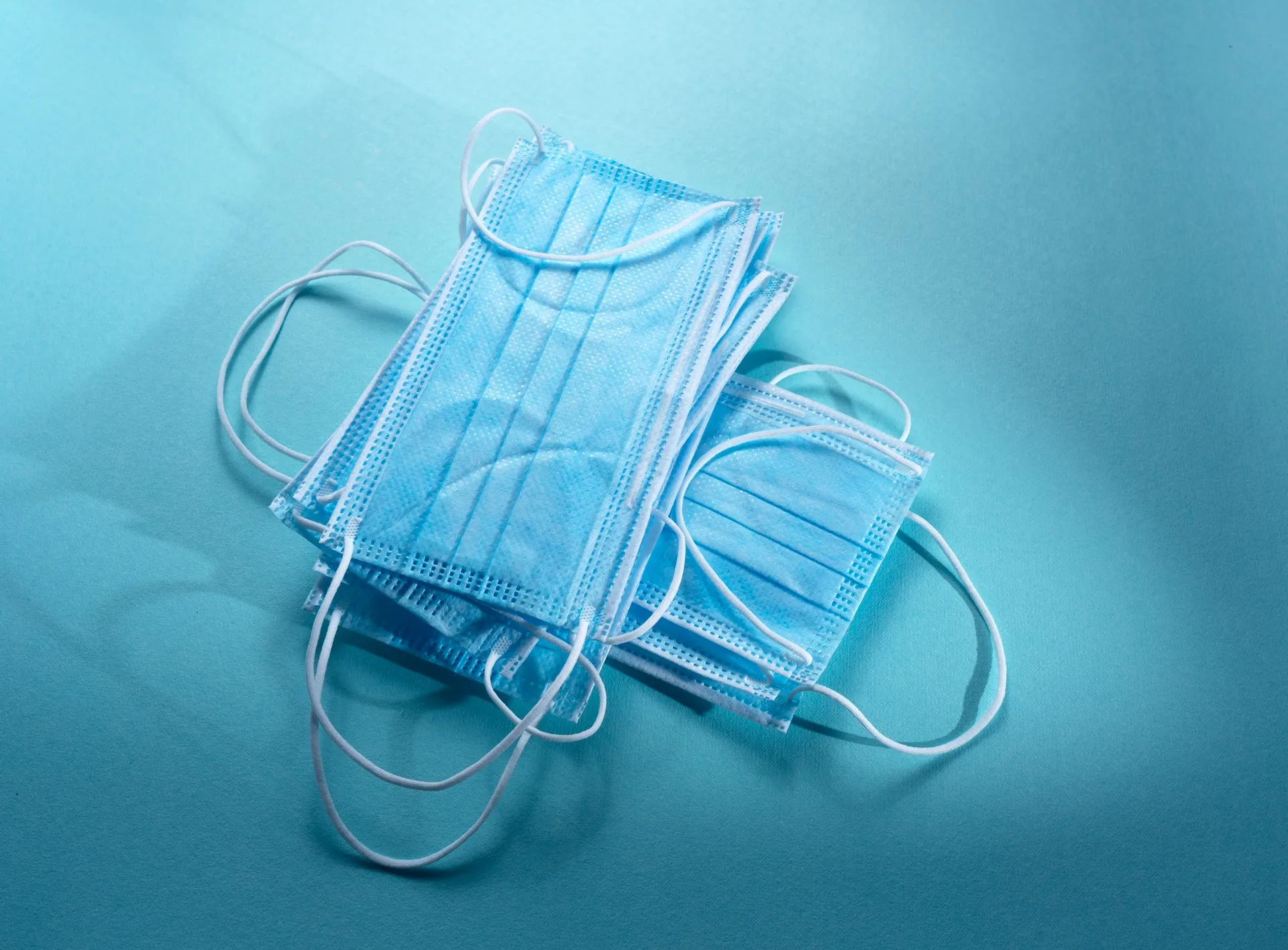 stack of masks on a blue background