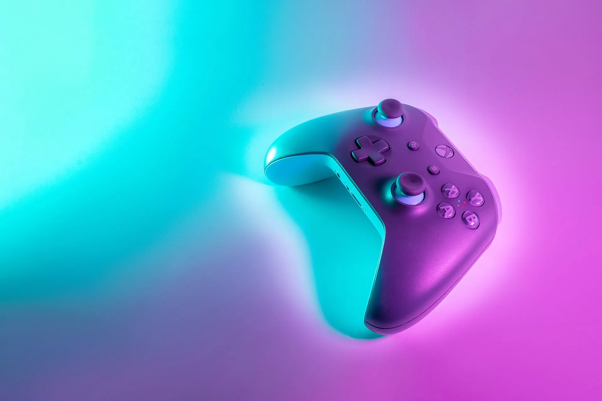 black xbox controller with vibrant background