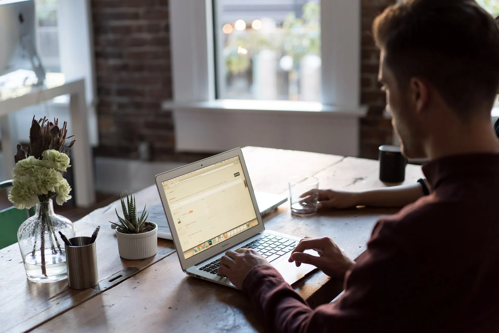 man using laptop on a desk