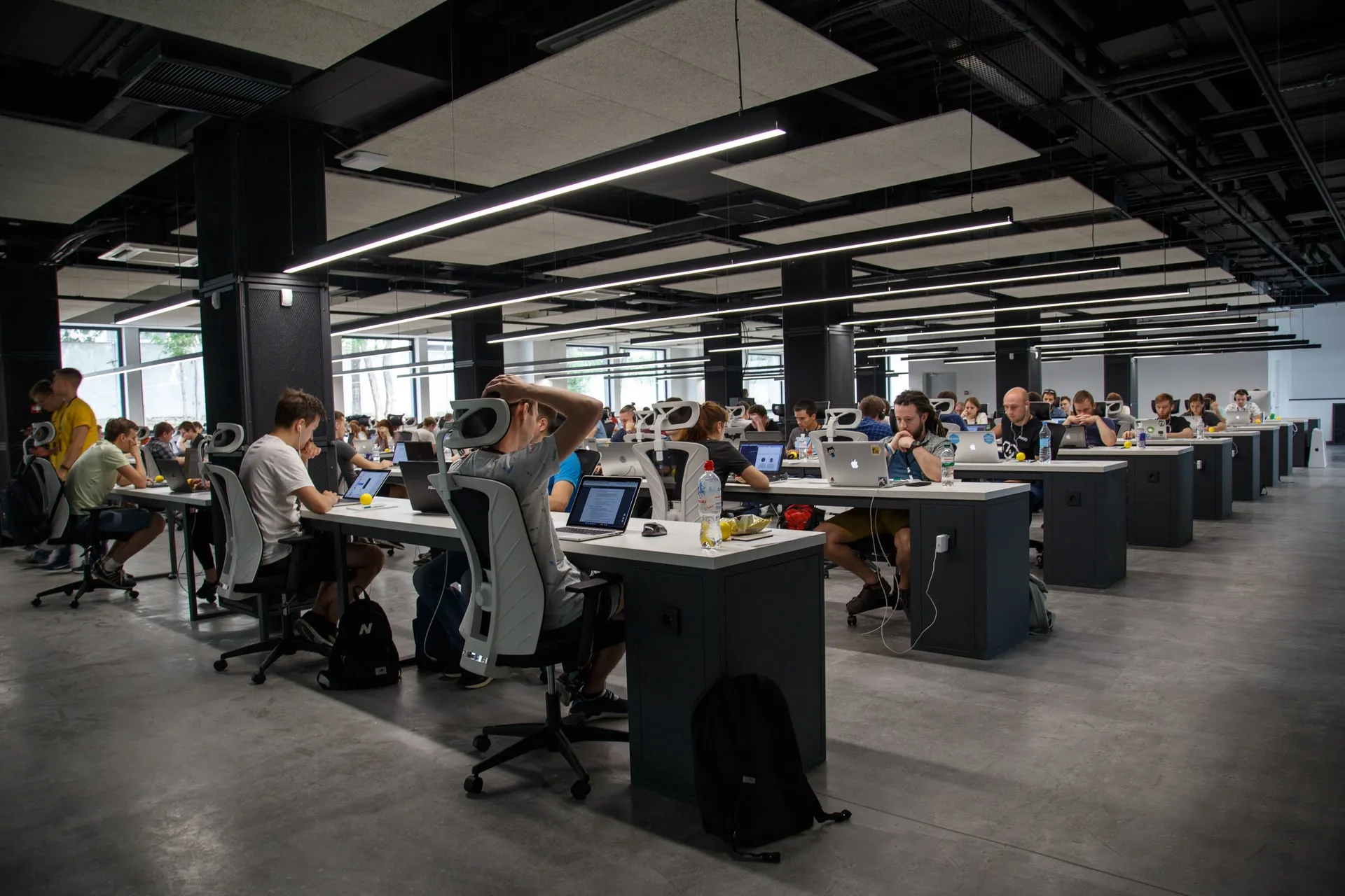 Open space office with people working on their laptops