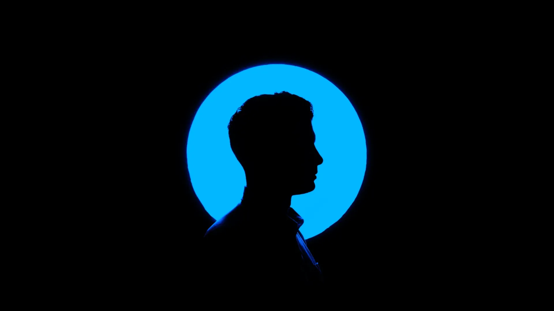 silhouette of a man with a blue circle around his head