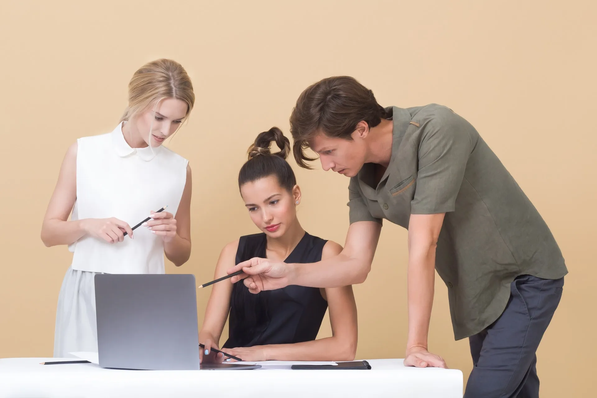 three people in front of computer